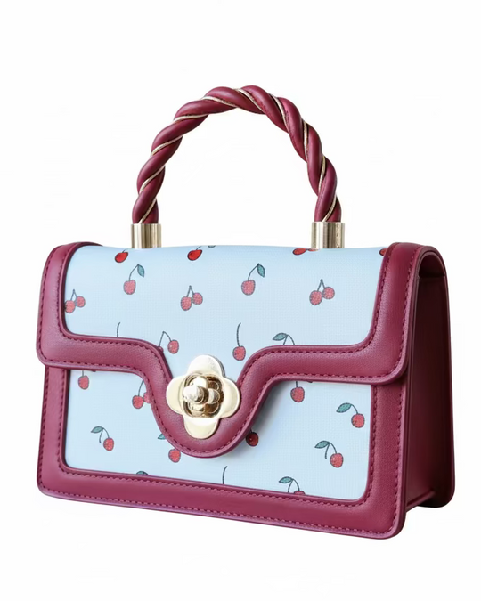 Red and White Handbag with cherry pattern and twisted handle on a white background
