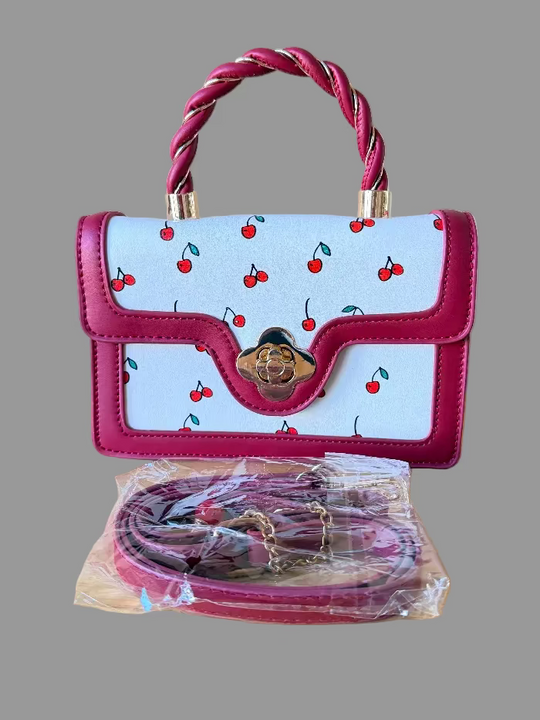 Red and White Handbag with cherry pattern and twisted handle on a gray background