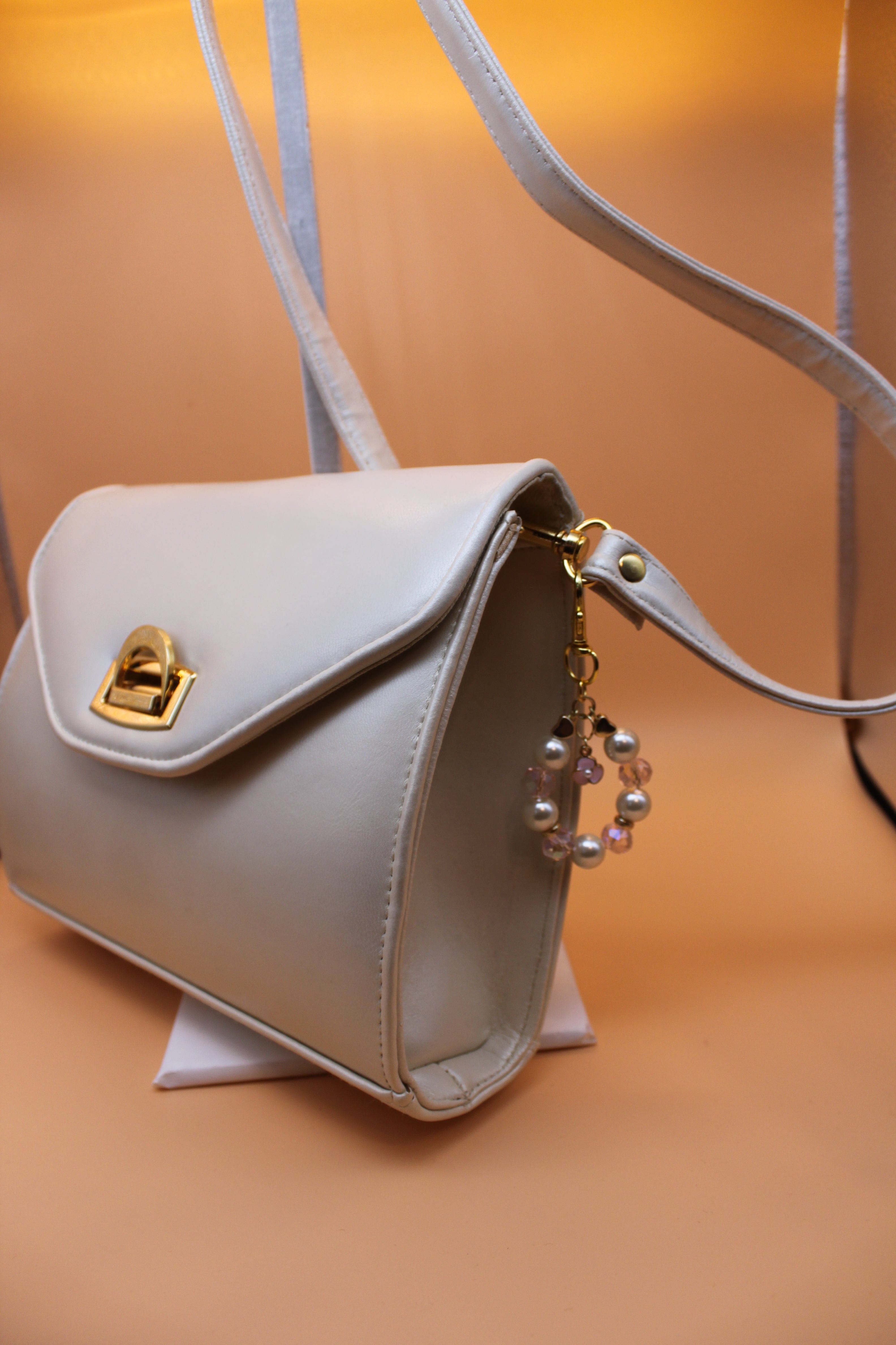 Crossbody Bag - Cream fashion handbag with adjustable strap and pretty bag charm - gold elements HB060