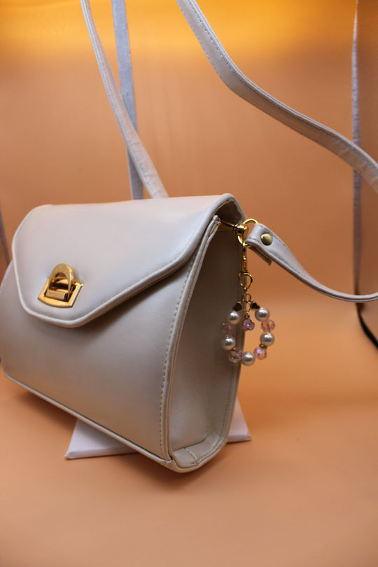 Crossbody Bag - Cream fashion handbag with adjustable strap and pretty bag charm - gold elements HB060